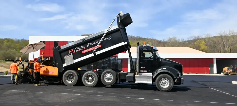 Pisa Paving crew and dump truck on a job site