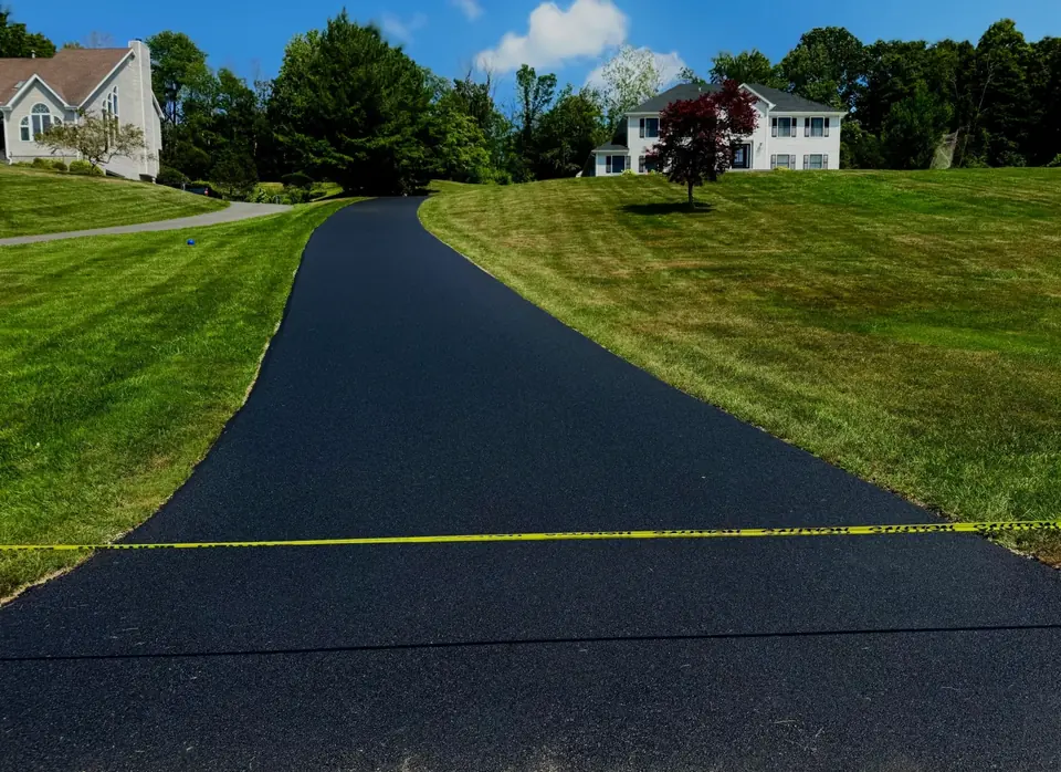 Pisa Paving asphalt driveway with a landscaped entrance