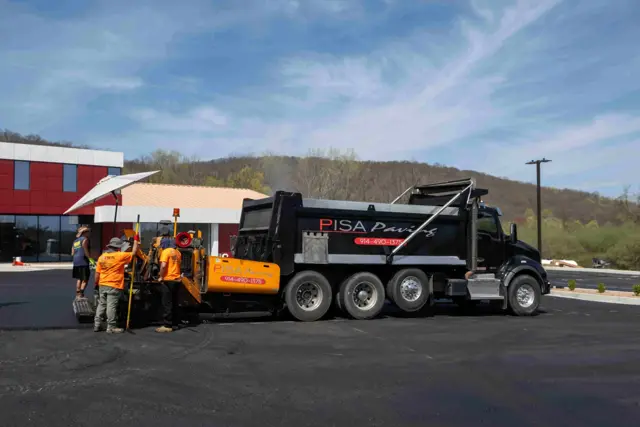 Crew paving a commercial lot